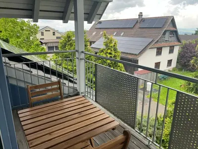 a living room with a television on a wooden table at Apartment with charm and dream view in Hosenruck