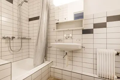 a white bathroom with a sink and a shower at SOHO 4B !Gratis Parken, Free Parking! in Kreuzlingen