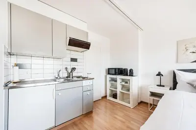 a white kitchen with a sink and a counter at SOHO 4B !Gratis Parken, Free Parking! in Kreuzlingen