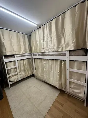 a room with two bunk beds with curtains at Hostel I Love Sg in St. Gallen