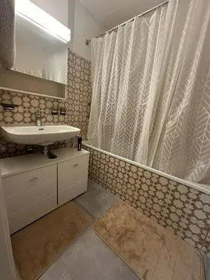 a bathroom with a sink and a shower curtain at Hostel I Love Sg in St. Gallen