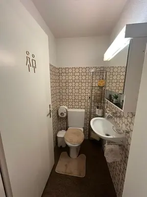 a small bathroom with a toilet and a sink at Hostel I Love Sg in St. Gallen