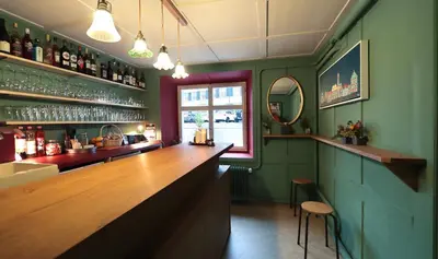 a bar with a wooden counter and a window at Krone Trogen in Trogen