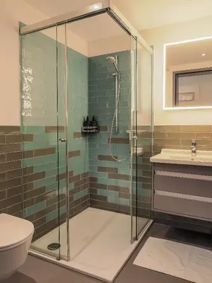 a bathroom with a shower and a toilet and a sink at Modernes Hostel, Privatzimmer in Shared Apartment, WYBA Living in St. Gallen
