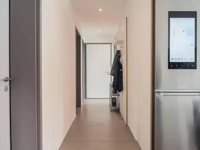 a hallway with a refrigerator in a room at Modernes Hostel, Privatzimmer in Shared Apartment, WYBA Living in St. Gallen