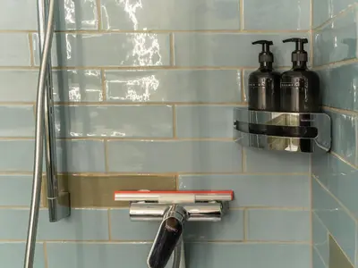 a bathroom with two soap dispensers on a wall at Modernes Hostel, Privatzimmer in Shared Apartment, WYBA Living in St. Gallen