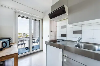 a kitchen with a sink and a view of a balcony at SOHO3A !Gratis Parken, Free Parking! in Kreuzlingen
