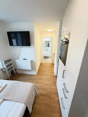 a small room with a kitchen and a living room at St Gallen City - 5 min vom Bahnhof - Roter Platz in St. Gallen
