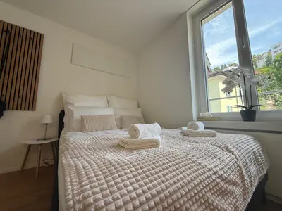 a bedroom with a bed with towels on it at St Gallen City - 5 min vom Bahnhof - Roter Platz in St. Gallen