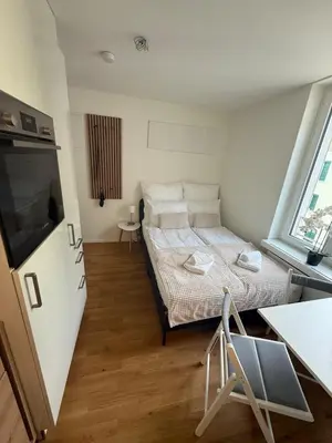 a small room with a bed and a tv at St Gallen City - 5 min vom Bahnhof - Roter Platz in St. Gallen