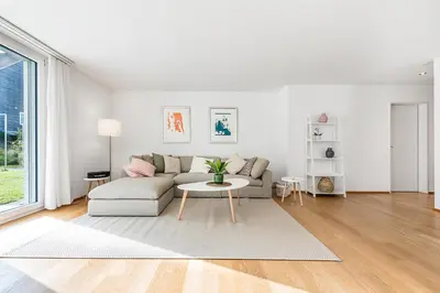 a white living room with a couch and a table at DESIGN-APARTMENT 1 !Gratis parken, Free Parking! in Kreuzlingen