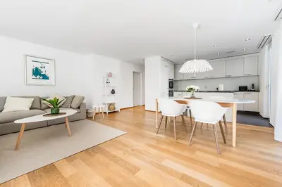 a living room and kitchen with a couch and a table at DESIGN-APARTMENT 1 !Gratis parken, Free Parking! in Kreuzlingen