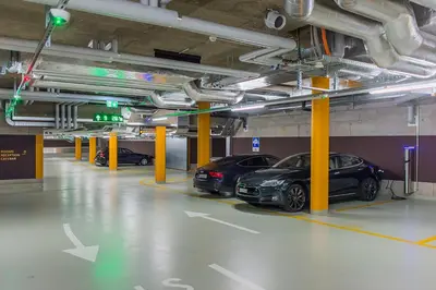 two cars are parked in a parking garage at Hotel one66 (free parking garage) in St. Gallen