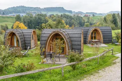 a group of three dome homes in a field at B&B Hofgenuss in Ganterschwil