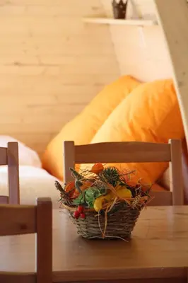 a basket of vegetables sitting on a chair on a table at B&B Hofgenuss in Ganterschwil