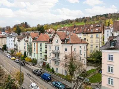 a city street with houses and cars on the road at BLIV Grosszügiges Altbaujuwel im Zentrum in St. Gallen