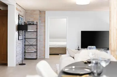 a living room with a white couch and a tv at BLIV Grosszügiges Altbaujuwel im Zentrum in St. Gallen