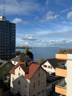 a view of the water from a city at HRE Apartments Lago Rorschach in Rorschach