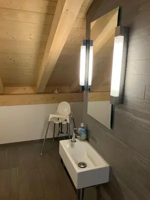 a bathroom with a white sink and a mirror at Ferienwohnung mit Sauna in Wildhaus in Wildhaus