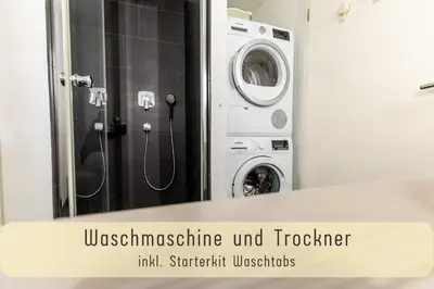 a washing machine in a bathroom with a mirror at Jasminkas Host 3 - Stadtwohnung mit Küche & gratis Parkplatz in St. Gallen