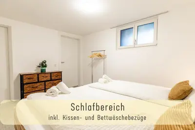 a bedroom with two beds and a window at Gemütliche Souterrainwohnung mit gratis Parkplatz in St. Gallen