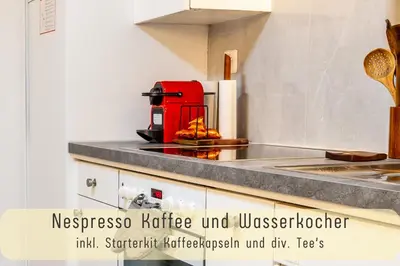 a kitchen with a red appliance on a counter at Gemütliche Souterrainwohnung mit gratis Parkplatz in St. Gallen