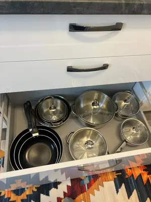 a bunch of pots and pans in a kitchen drawer at Luxuswohnung in Bodensee, im Radweg mit Parkplatz in Romanshorn