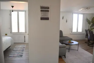 a room with a bed and a living room at Luxuswohnung in Bodensee, im Radweg mit Parkplatz in Romanshorn