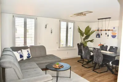 a living room with a couch and a table at Luxuswohnung in Bodensee, im Radweg mit Parkplatz in Romanshorn