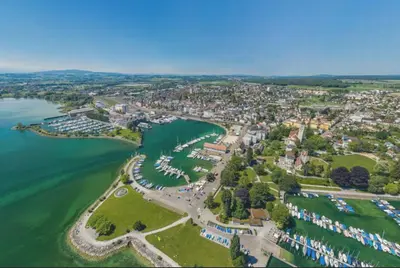 an aerial view of a town next to a body of water at Luxuswohnung in Bodensee, im Radweg mit Parkplatz in Romanshorn