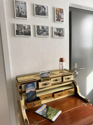 a room with a dresser with pictures on the wall at Alte Näherei in Degersheim