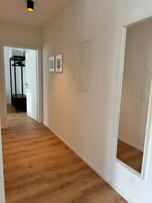 a hallway with a mirror on the wall at Alte Näherei in Degersheim