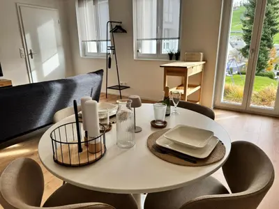 a white table and chairs in a living room at Alte Näherei in Degersheim