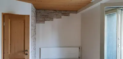 a room with white walls and a wooden ceiling at 3 Zi Gartenwohnung in Buchs