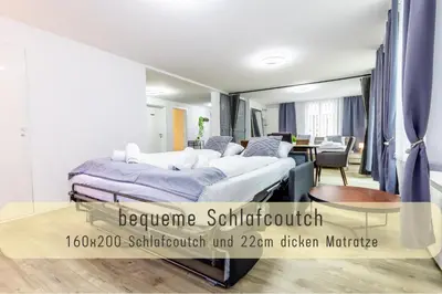 a hospital room with a bed and a table at Modern 80qm Flat with Balcony & free Parking in St. Gallen