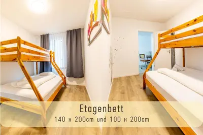 a room with two bunk beds in a hostel at Modern 80qm Flat with Balcony & free Parking in St. Gallen