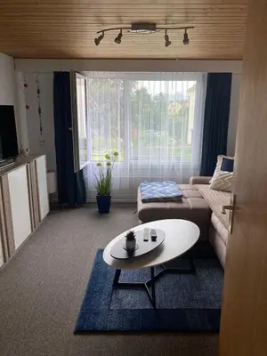 a living room with a couch and a table at Dachwohnung in Niederuzwil