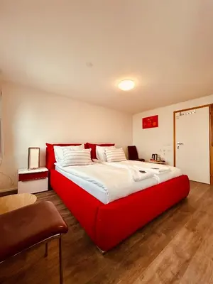 a bedroom with a large red bed in a room at Romantic Room, Private Bathroom and Great View in Heiden