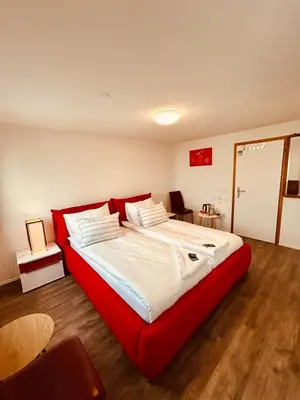a large bed in a room with a red frame at Romantic Room, Private Bathroom and Great View in Heiden