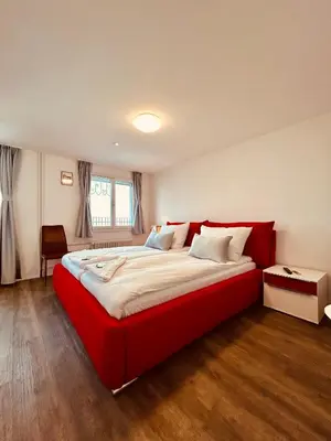 a bedroom with a large red bed in a room at Romantic Room, Private Bathroom and Great View in Heiden