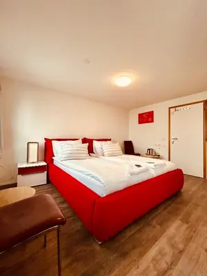 a bedroom with a large red bed in a room at Romantic Room, Private Bathroom and Great View in Heiden