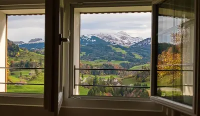 a window with a view of mountains at BnB Sonder in Urnäsch
