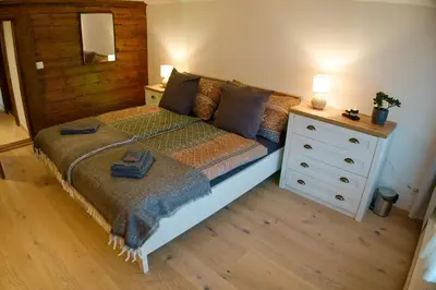 a bedroom with a bed and a dresser at BnB Sonder in Urnäsch