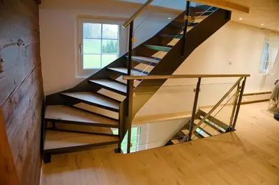 a staircase in a house with a glass railing at BnB Sonder in Urnäsch