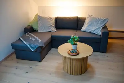 a living room with a couch and a table at BnB Sonder in Urnäsch