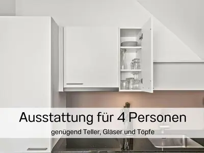 a kitchen with white cabinets in a kitchen at Ferienhausträume Bergstrasse Bodensee - inkl Tiefgarage, Garten und Dachterrasse in Kreuzlingen