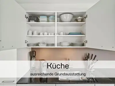a kitchen with white cupboards with dishes on them at Ferienhausträume Bergstrasse Bodensee - inkl Tiefgarage, Garten und Dachterrasse in Kreuzlingen