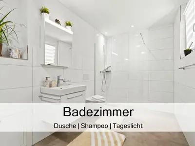 a white bathroom with a shower and a sink at Ferienhausträume Bergstrasse Bodensee - inkl Tiefgarage, Garten und Dachterrasse in Kreuzlingen