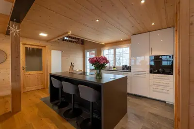 a kitchen with a island with a vase of flowers at Ganzes Haus am Bodensee in den Bergen im Appenzell in Heiden