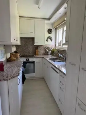 a kitchen with white cabinets and white appliances at 3 Zimmerwohnung mit Gartenterrasse, mitten im idyllischen Gais für 1 bis 3 Personen in Gais